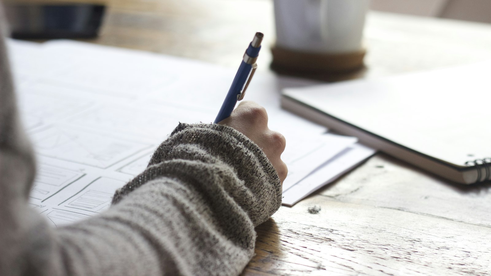 A focused workspace with a laptop, open notebooks and study materials