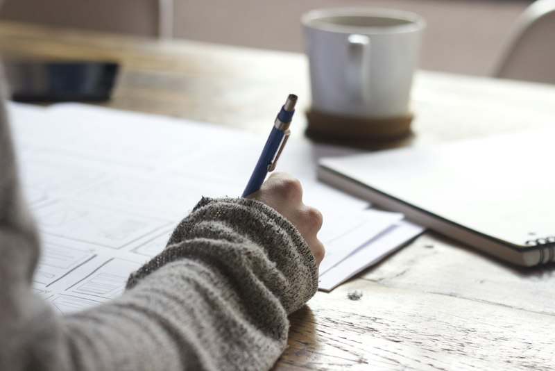 A focused workspace with a laptop, open notebooks and study materials