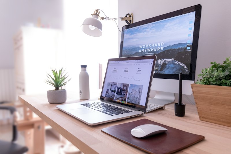 A desk with a dual-monitor computer setup