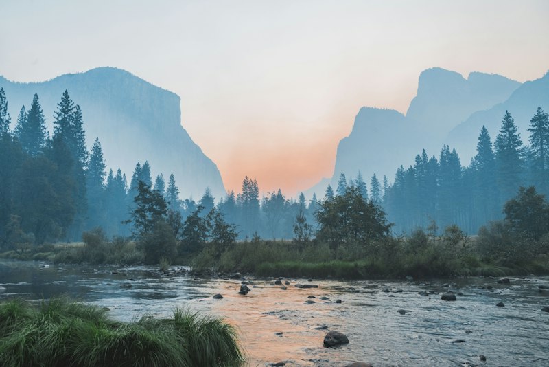 A calm mountain landscape under soft light