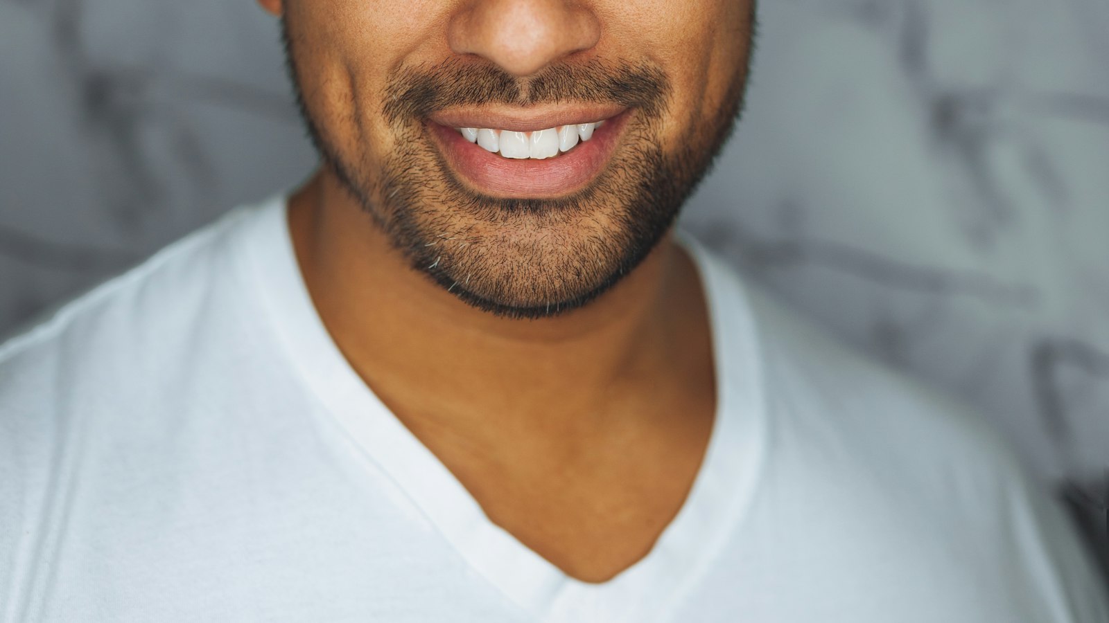 A person smiling confidently in an office setting