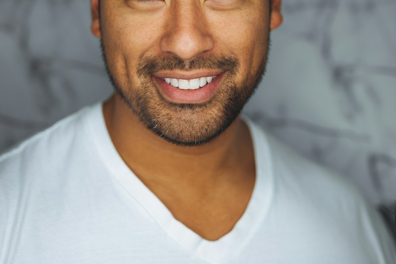 A person smiling confidently in an office setting