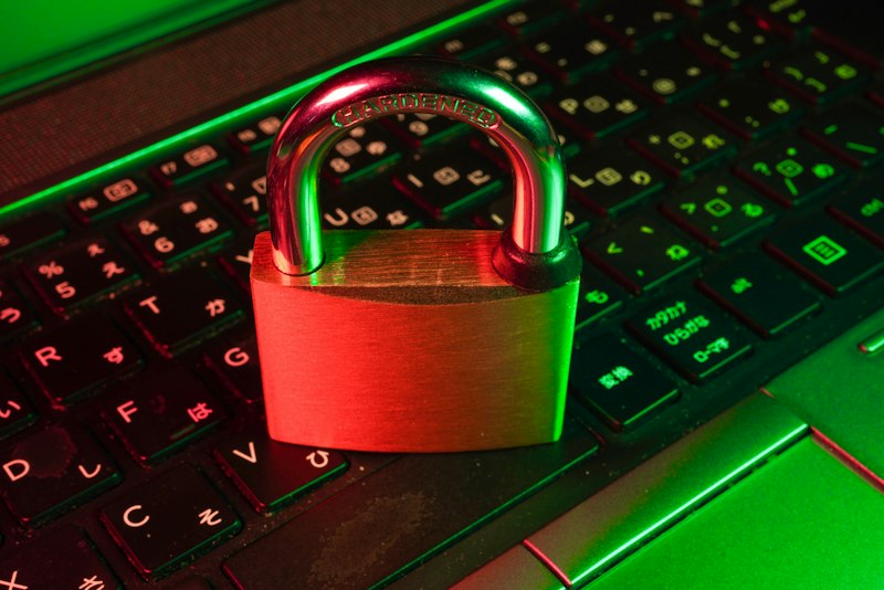 A red padlock resting on a laptop keyboard